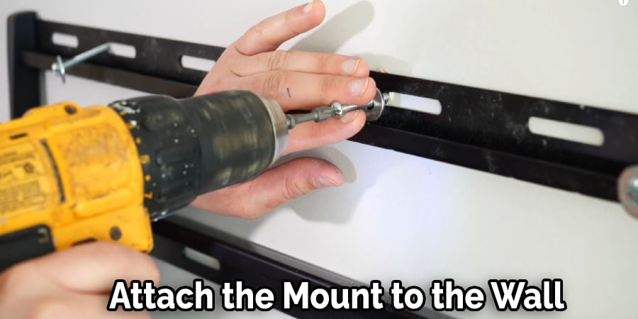 Screw the mount into the wall using the screws it comes with