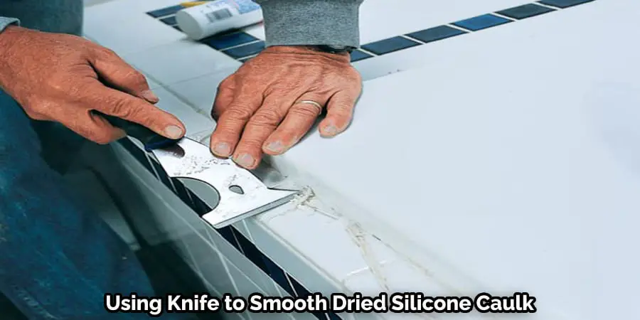 Using Knife to Smooth Dried Silicone Caulk