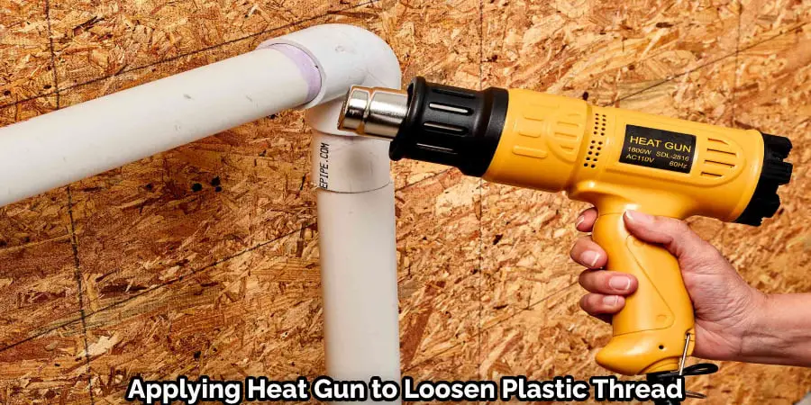 Applying Heat Gun to Loosen Plastic Thread